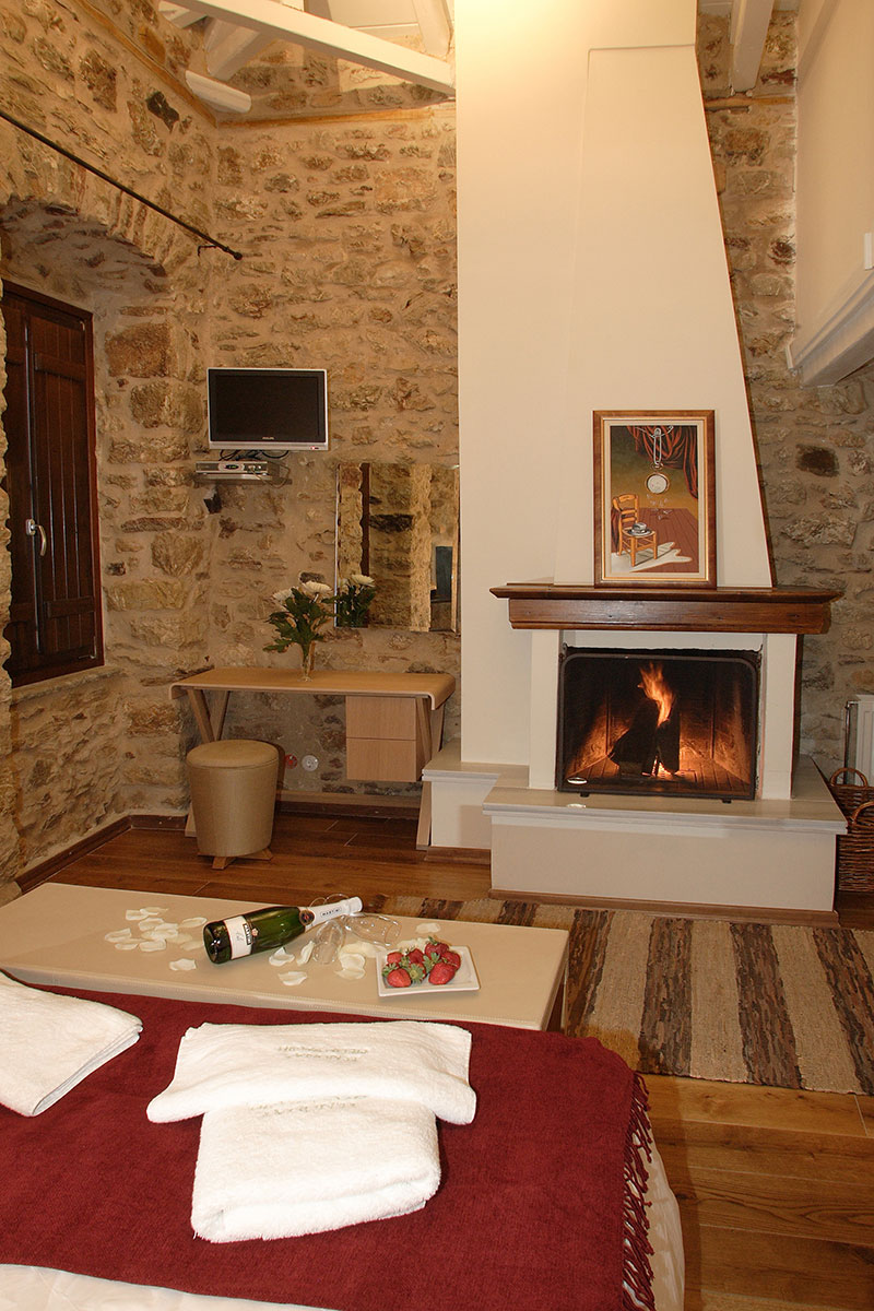 Comfortable bedroom with fireplace in the guesthouse Theonimfi in Dimitsana